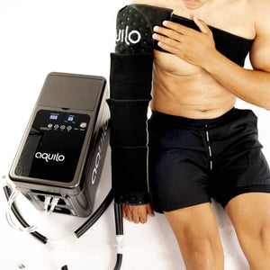 A man wearing an arm wrap connected to the cryo-compression control unit.