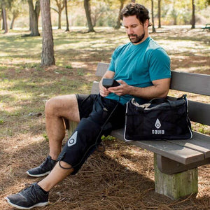 Man on bench using the Squid Go Cold & Compression System